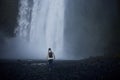 Girl runs to the skogafoss waterfall Royalty Free Stock Photo