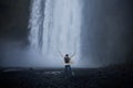 Girl runs to the skogafoss waterfall Royalty Free Stock Photo