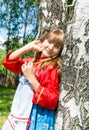 Girl in Russian clothes in summer landscape outdoor