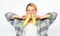 Girl rustic style bites ripe corn. Girl eating uncooked and unprocessed food. Woman farmer eat two yellow corn cobs on