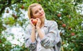 Girl rustic style gather harvest garden autumn day. Farmer pretty blonde with appetite red apple. Harvesting season Royalty Free Stock Photo