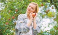 Girl rustic style gather harvest garden autumn day. Farmer pretty blonde with appetite red apple. Harvesting season Royalty Free Stock Photo