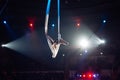 Girl`s aerial acrobatics in the Circus ring. Royalty Free Stock Photo