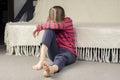 Girl`s bare feet. Foot heel. Sad little girl sitting on the floor. European Royalty Free Stock Photo