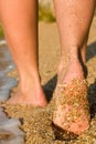Girl's barefoot feet in sea surf
