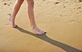 Girl's barefoot legs on the sand beach Royalty Free Stock Photo