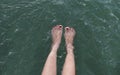 Girl's beauty legs in the pool making splashes shallow depth of