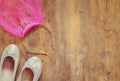 Girl's diamond tiara with pink chiffon vail next to ballet shoes