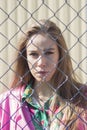 The girl`s face against the background of the lattice. Royalty Free Stock Photo