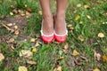 Girl's feet inshoes standing on grass