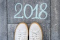 The girl`s foot and the text 2018, written on the asphalt Royalty Free Stock Photo