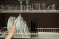 Graceful hand of woman takes out a clean plate from the cupboard Royalty Free Stock Photo