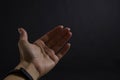 Girl`s hand on a black background stretched forward inviting or showing somewhere.