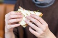 Girl`s hand holding a fresh delicious club sandwich Royalty Free Stock Photo