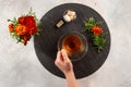 The girl`s hand holds a cup of tea. Marigold flowers. Flat lay.  Morning still life, tea time Royalty Free Stock Photo