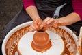 Girl`s hand in the process of making clay pottery on a potter`s wheel Royalty Free Stock Photo