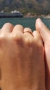 Girl s hand with a ring hepkily squeezes a guy s hand on the background of a cruise ship Royalty Free Stock Photo