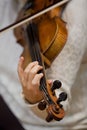 Girl's hand on the strings of a violin