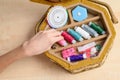 The girl`s hand takes a spool of pink thread. Royalty Free Stock Photo