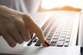 Girl`s hand typing on a laptop keyboard, she presses Enter key, moment of confirmation, close-up Royalty Free Stock Photo