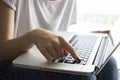 Girl`s hand typing on a laptop keyboard, she presses Enter key, moment of confirmation, close-up Royalty Free Stock Photo