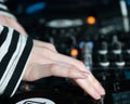 Girl`s hands changing settings on a sound mixer for DJs
