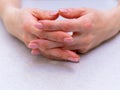 The girl`s hands with extended manicure on a bright table