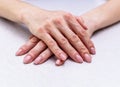 The girl`s hands with extended manicure lie on the bright table Royalty Free Stock Photo