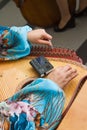 Girl`s hands fine tune a bandura, Ukrainian national folk string instrument, at a rehearsal before a concert