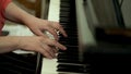 Girl`s hands on the keyboard of the piano. The girl plays piano,close up piano. Hands on the white keys of the Piano Royalty Free Stock Photo