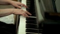 Girl`s hands on the keyboard of the piano. The girl plays piano,close up piano. Hands on the white keys of the Piano Royalty Free Stock Photo