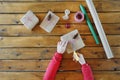 Girl`s hands are packing Christmas gift on background