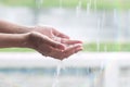 Girl's hands playing catch the rain on a rainy day.Happiness in the pure spring weather under the rainy season Royalty Free Stock Photo