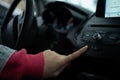 Girl\'s Hands Pressing the Hazard Warning Lights Button in a Car