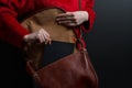 Girl`s hands pull out a notebook from a vintage leather bag, girl`s hands put a notebook in a vintage leather bag, black notepad i Royalty Free Stock Photo