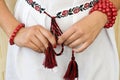 Girl's hands with red bracelets and traditional embroidered shirt Royalty Free Stock Photo