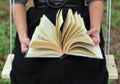 Girl's hands turning the book pages