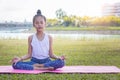 Girl`s happy and Meditate on the practice of yoga in the park