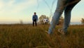 Girl`s leg hits soccer ball man catches ball. family plays football in park. dad and daughter play ball on the field. Royalty Free Stock Photo