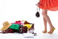 Girl's legs near overfilled suitcase. Royalty Free Stock Photo