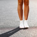 Girl`s legs in sneakers - close up