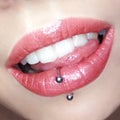 Girl`s lips make-up lipstick lip gloss cosmetic swatch teeth tongue piercing fashion macro photo Royalty Free Stock Photo