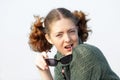 Old-fashioned Young curly girl in a vintage gray knitted dress