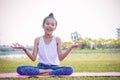 Girl`s practicing yoga in the park Strengthens concentration an