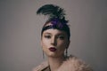 Girl in the 90s style, chicago style. Hat, headband with decorative feathers on the head. Incredible jewelry, long earrings with