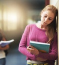 Girl, sad and school bullying with book, anxiety and depression from problem with students at academy. Young, teenager Royalty Free Stock Photo