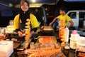 Girl sale fried potatoes in the temporary night market Royalty Free Stock Photo