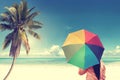 Girl on a sandy beach with colorful rainbow umbrella, Royalty Free Stock Photo