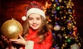 Girl santa claus costume hold big ball christmas tree ornaments. Christmas decorations. Love to decorate everything Royalty Free Stock Photo