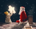 Girl and Santa Claus sitting on the roof Royalty Free Stock Photo